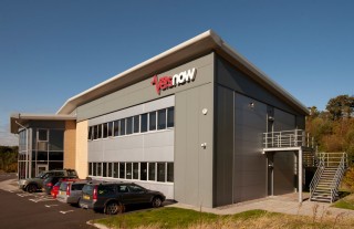 A modern building with a gray exterior displays the text 