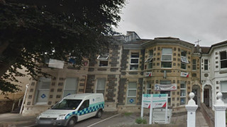 Van parked on a sloped driveway beside a three-story stone building with bay windows and a tiled roof. Signage reads: “Vision†and “Salisbury Crescent Dental Practice.†Trees partially obscure the view. Van parked on a sloped driveway beside a three-story stone building with bay windows and a tiled roof. Signage reads: “Vision†and “Salisbury Crescent Dental Practice.†Trees partially obscure the view.