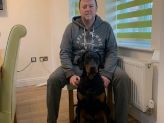 Image of Maiu the Doberman with his owner at home for Vets Now article on puppy eating rocks
