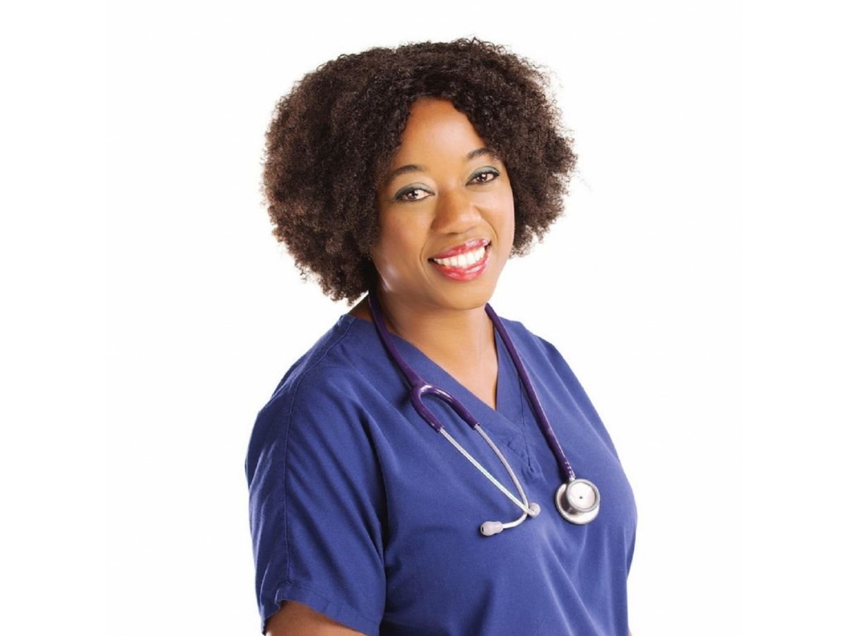 Mandisa Greene A healthcare professional wearing blue scrubs and a stethoscope smiles against a plain white background.