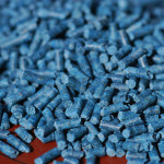 a batch of blue slug pellets on a brown surface
