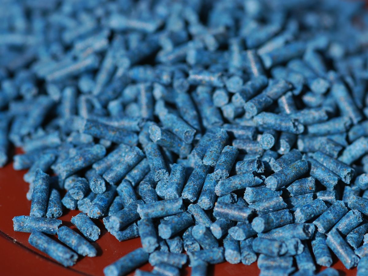a batch of blue slug pellets on a brown surface
