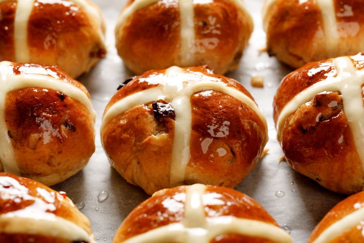 hot_cross_buns Close-up of golden brown hot cross buns with a shiny glaze.