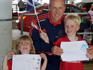 Iain's proud children greeting him at the airport Image of Iain and his children for Vets Now article on staff sporting achievements