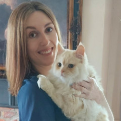 Locum vet nurse Tracy holding her cat in her arms