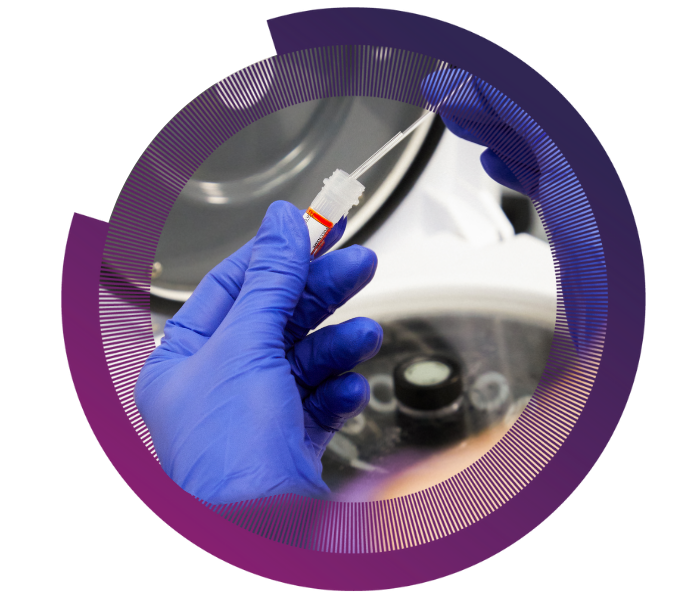 Gloved hands hold a test tube with a pipette in a laboratory, against a circular, purple gradient background.