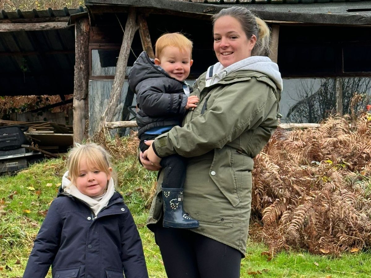 Nina Seib holding her son and standing next to her daughter outdoors on a family day out